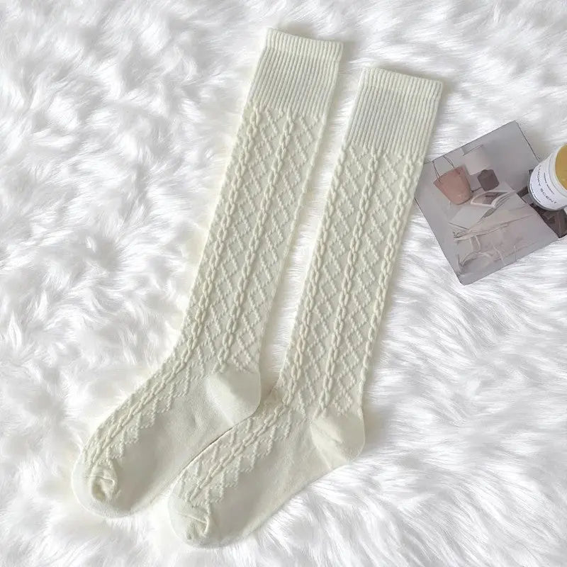 Chaussettes hautes pour femme en blanc cassé, tricot fin et chic.
