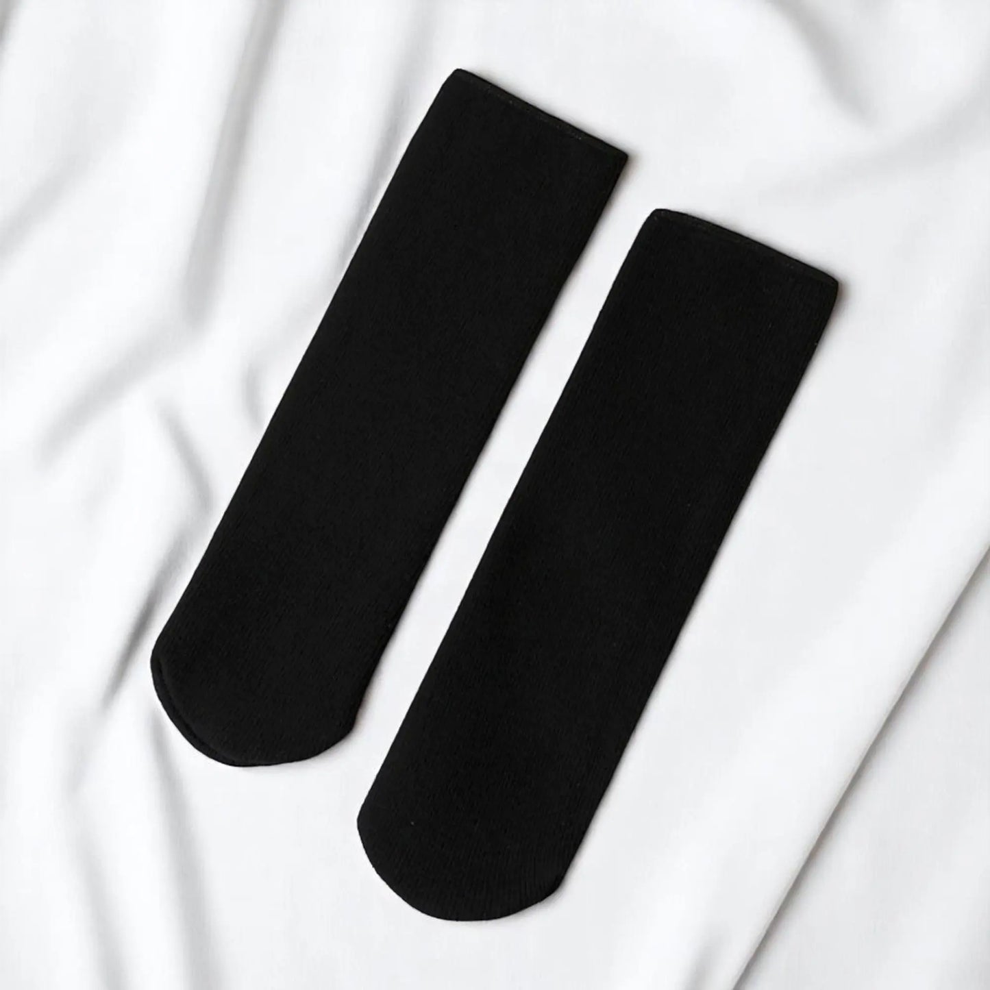 Paire de chaussettes d'hiver noires pour homme, chaleur et style.
